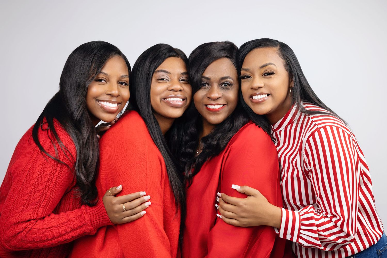 A group wearing red and white outfits pose together for a series of festive holiday photos.