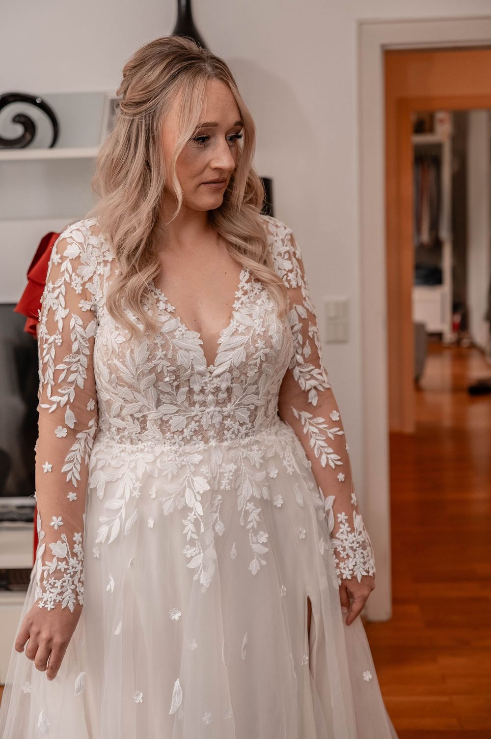 Wedding dress detail showing delicate white lace appliques and sheer fabric in an elegant bridal gown design.