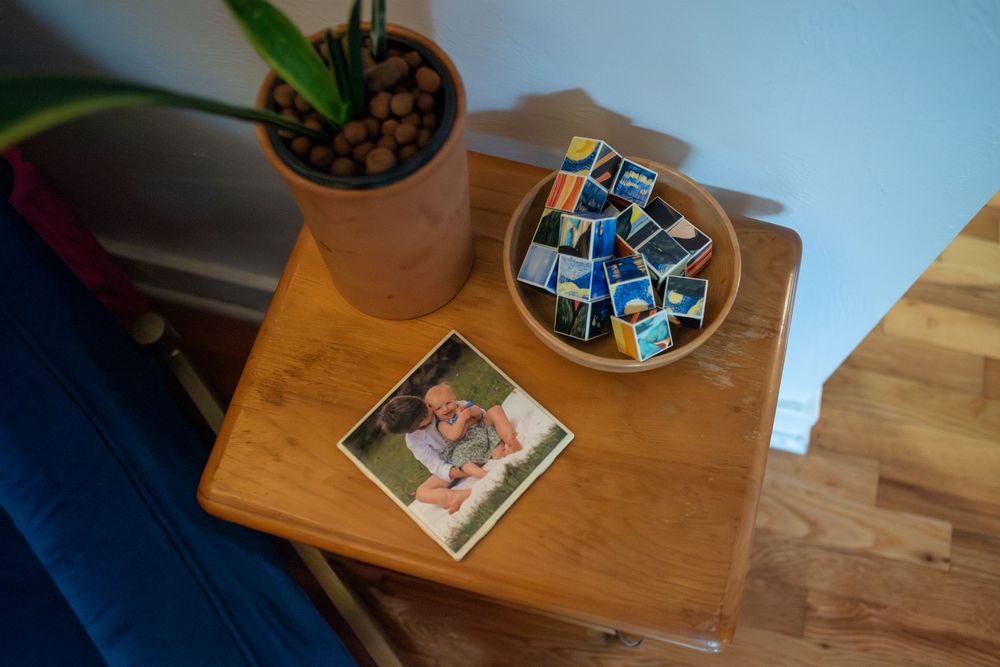 A nostalgic coaster with small children printed on it with a bowl of art cubes next to it in Lansing, Michigan