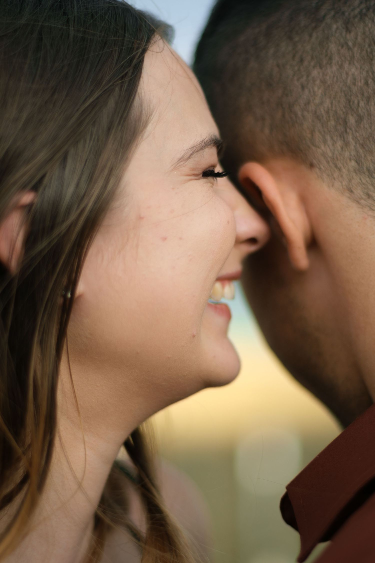 Close up silhouette of couple in intimate moment with soft lighting.