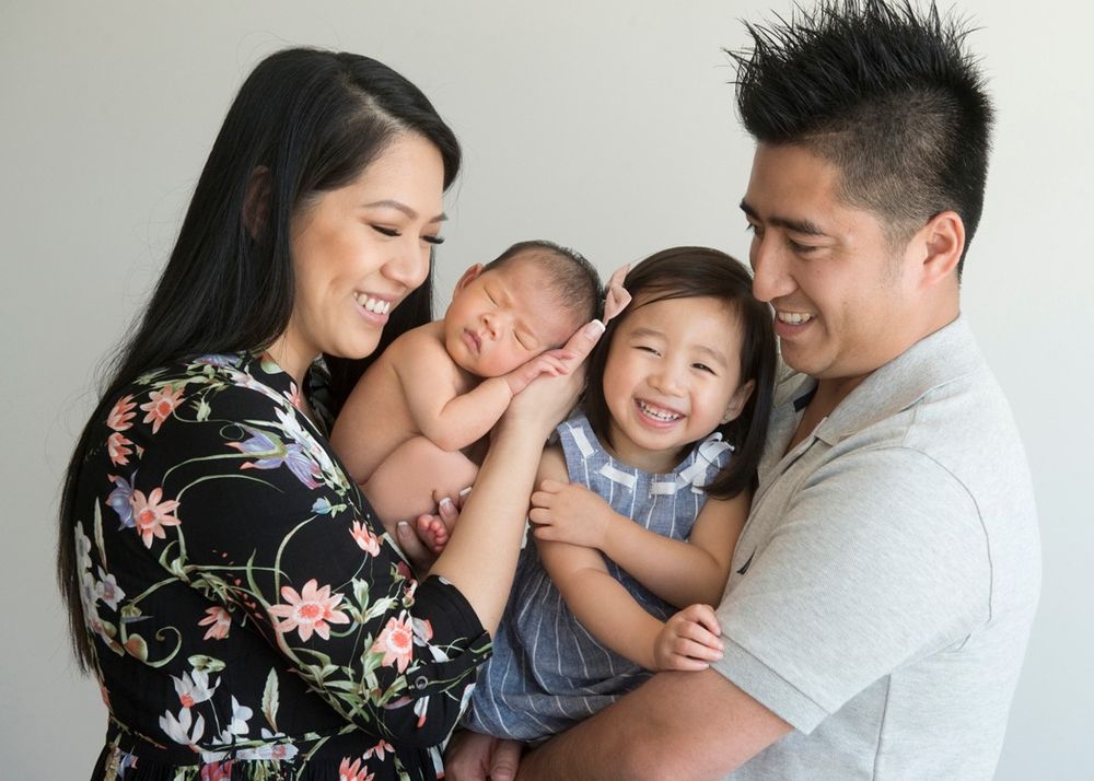 Candid family photography session showing joyful interactions in casual attire.