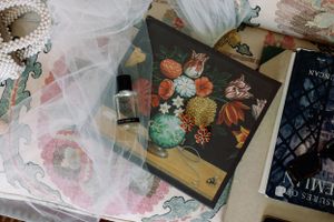 Vintage floral illustration book with orange and green botanical prints.