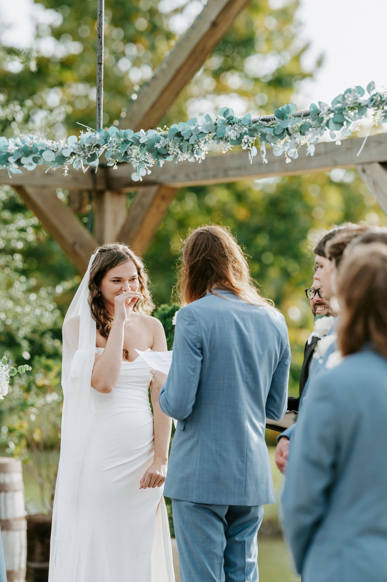 A sequence of candid wedding moments showing a couple and guests during an outdoor ceremony under string lights.