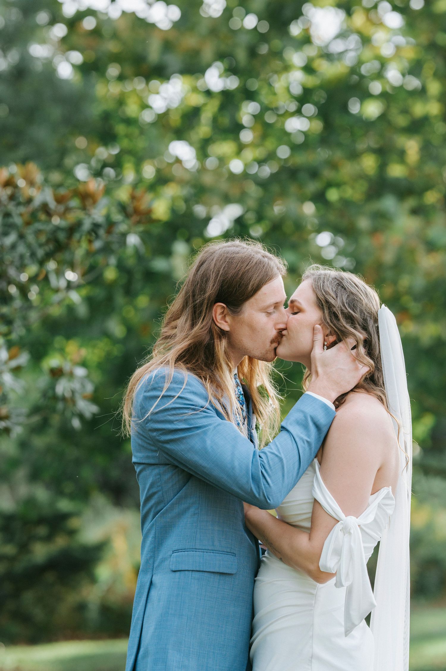 A romantic outdoor wedding moment captured in a series of four photos with a beautiful natural green backdrop.