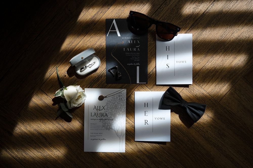 Editorial wedding stationery flat lay with invitations, rings and luxury styling details