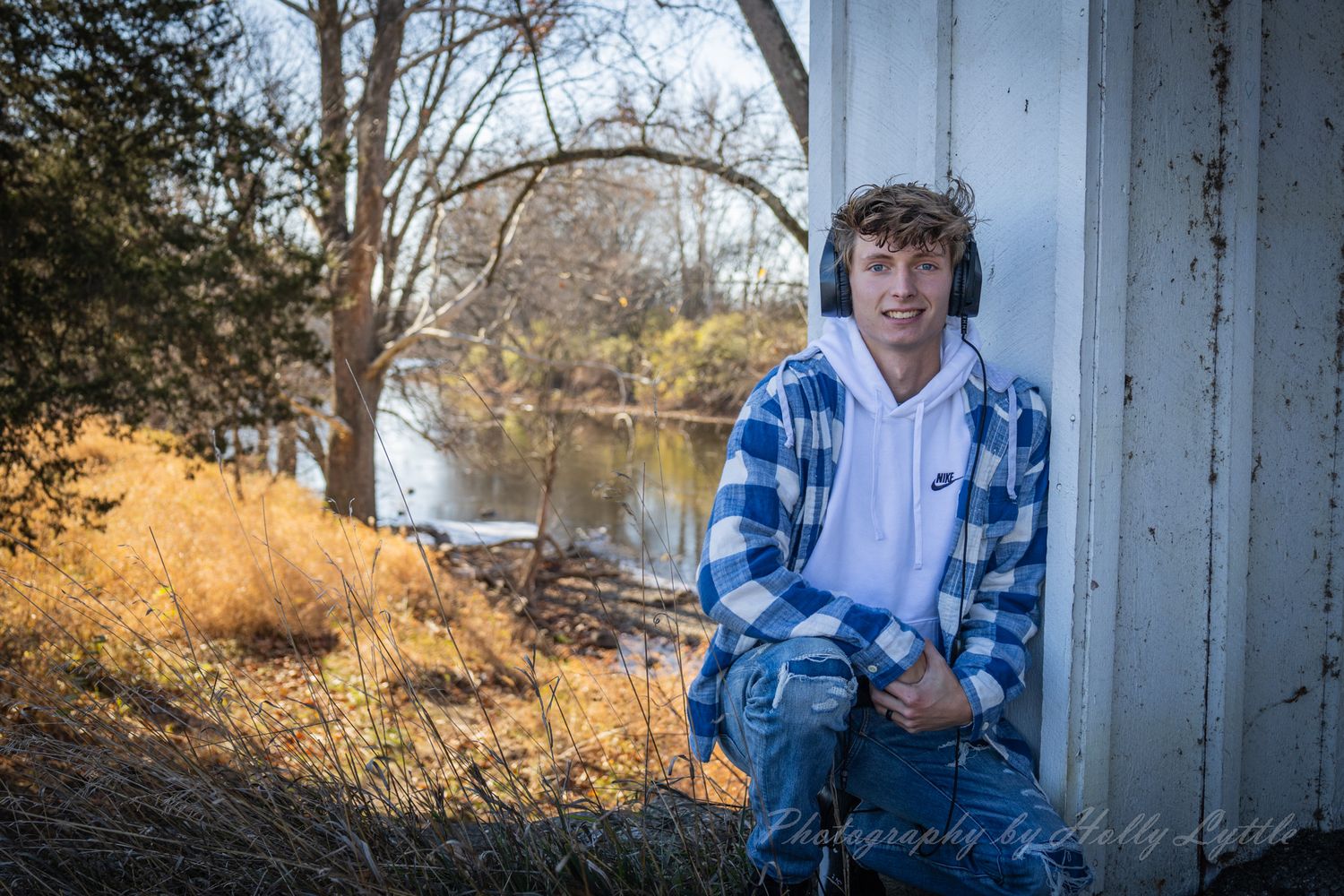 A series of outdoor portrait photographs showing someone wearing blue plaid against rustic backgrounds and wooden walls.