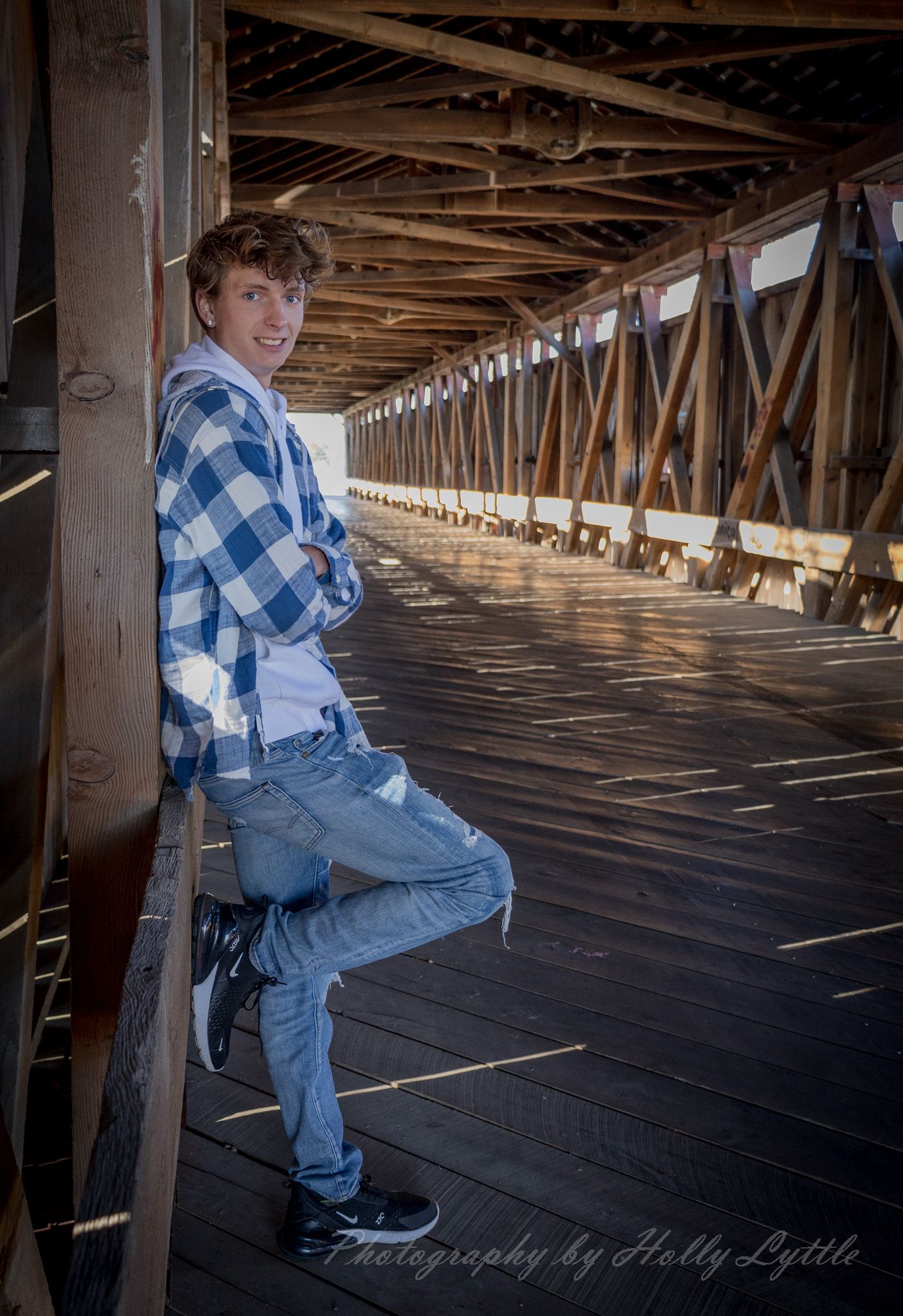 Interior shots of a covered wooden bridge showing a rustic wooden floor and beams with natural lighting.