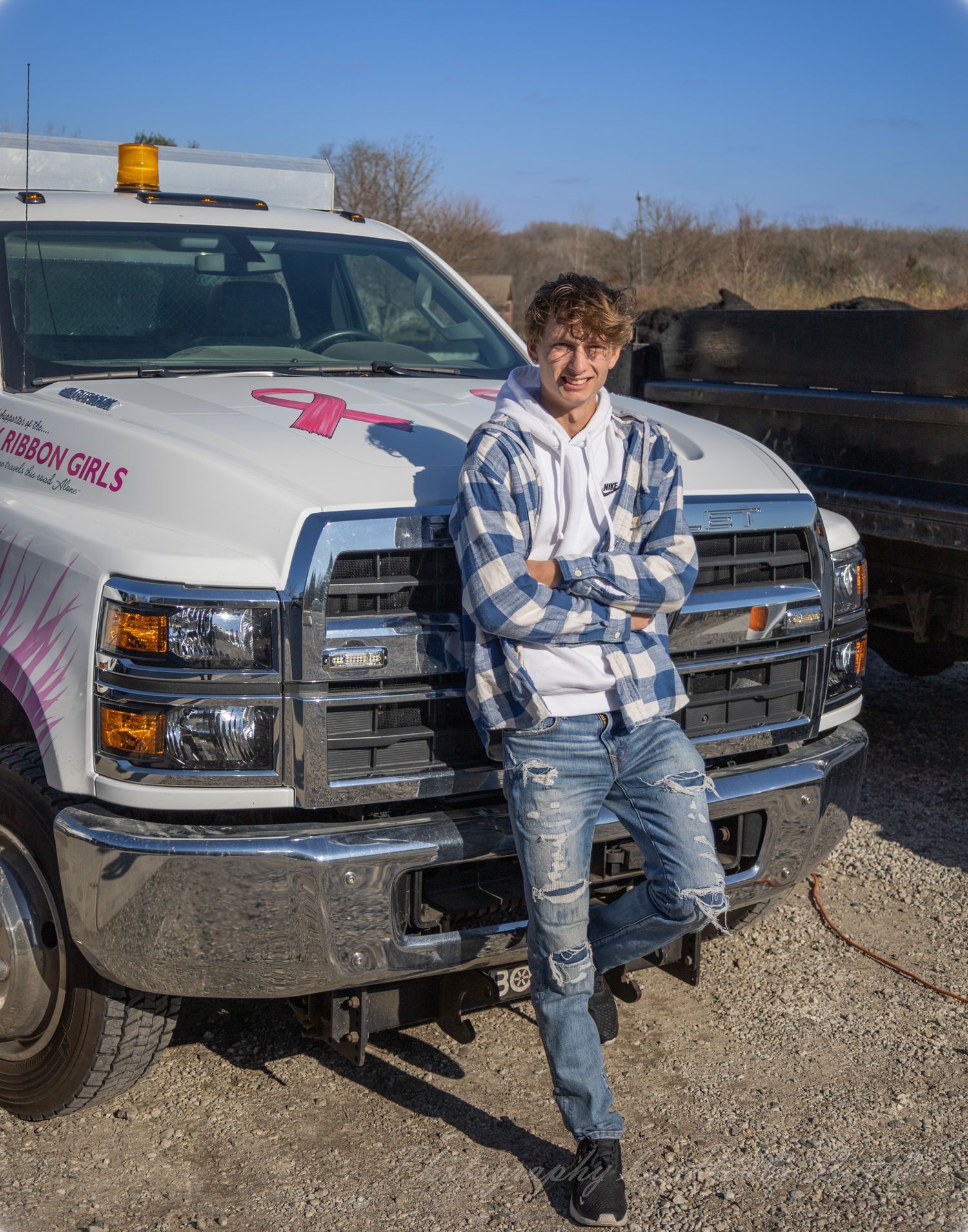 Casual outdoor photos by parked trucks wearing blue plaid and denim.
