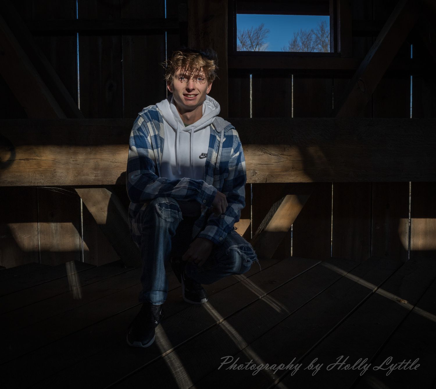 A moody portrait series in dark lighting against a wooden backdrop.