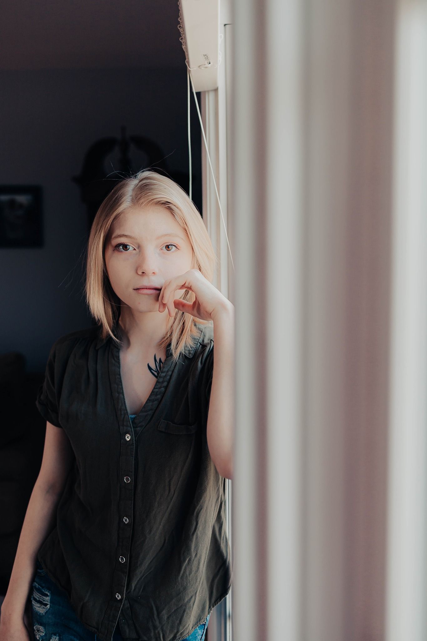 Artistic portrait series showing playful expressions against a white wall.