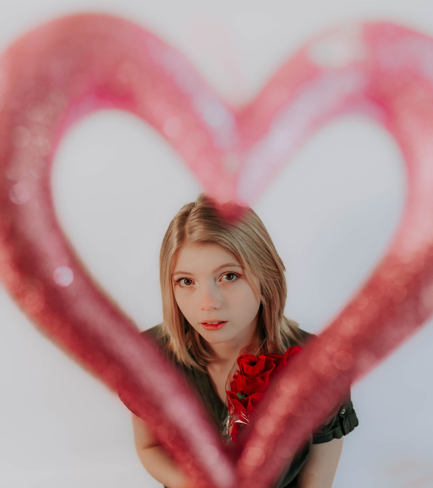 Creative portrait series with red heart bokeh effects and romantic styling.
