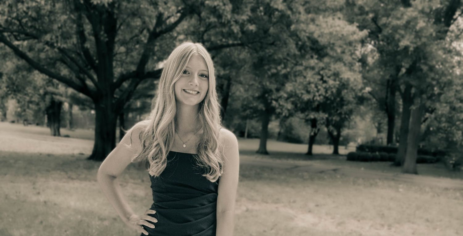 Black and white outdoor portrait series in natural setting with trees and grass.