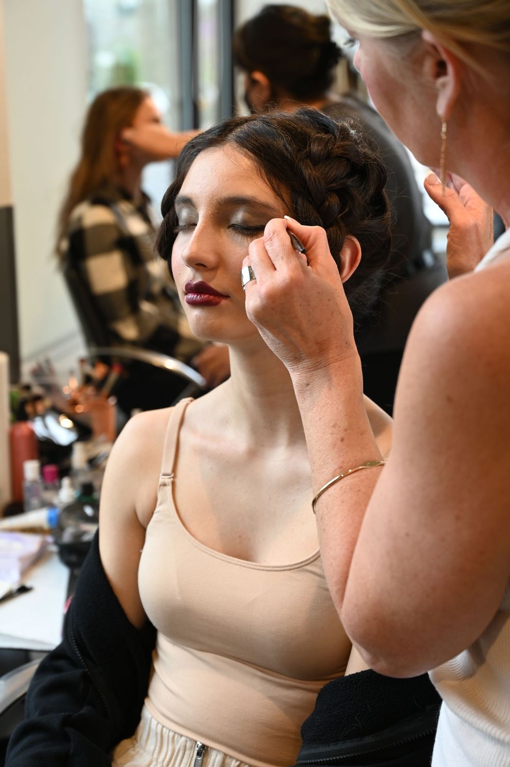 A series of candid shots showing makeup application and preparation in a bridal getting ready room.