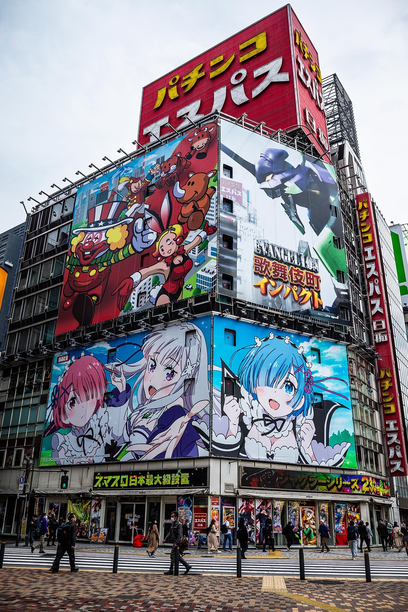 Colorful anime-style murals and advertisements painted on buildings in Akihabara, Tokyo's famous electronics district.
