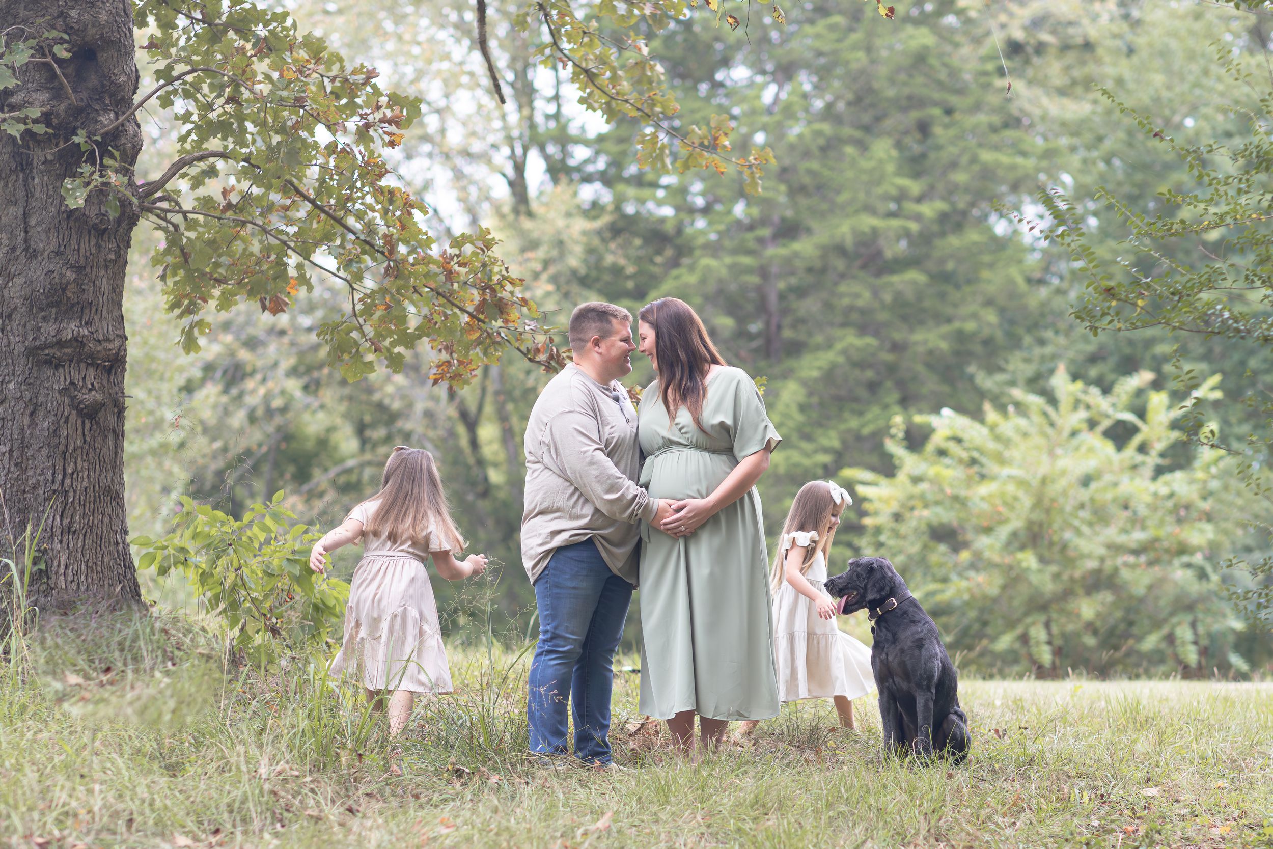 Family gathering in a serene wooded setting during golden hour.