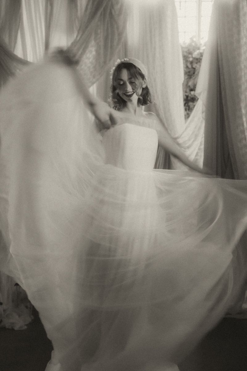 A dreamy sequence of black and white photos showing a flowing white wedding dress in ethereal motion.
