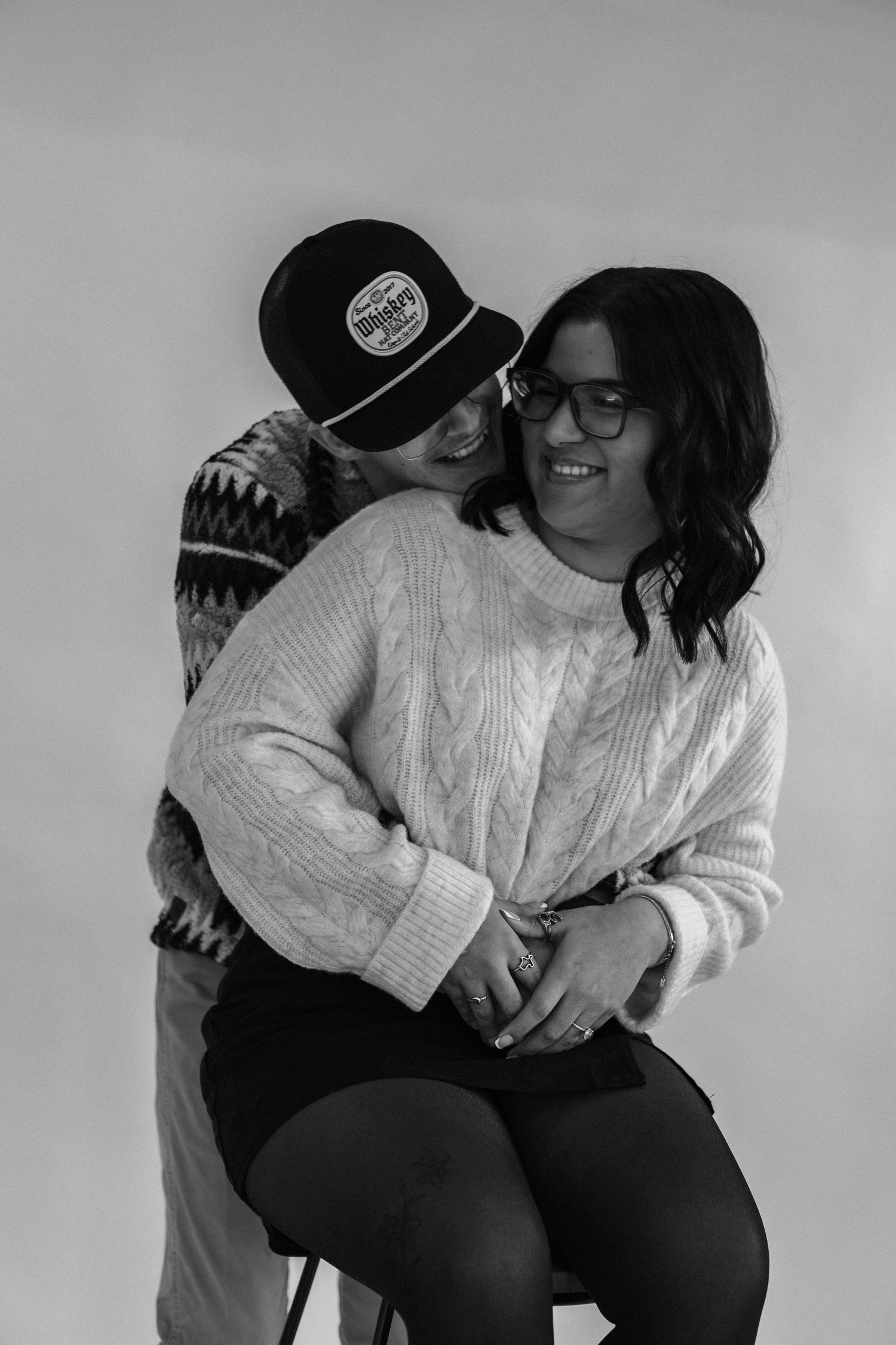 A playful black and white photo series of two people in cozy sweaters.
