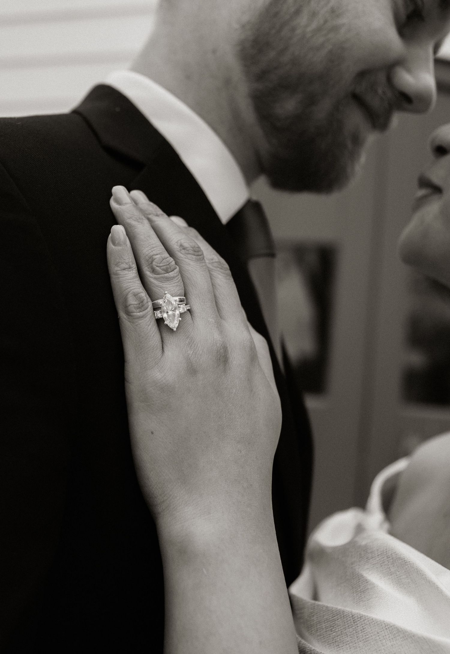 Close-up shots focusing on hands with engagement rings in black and white.