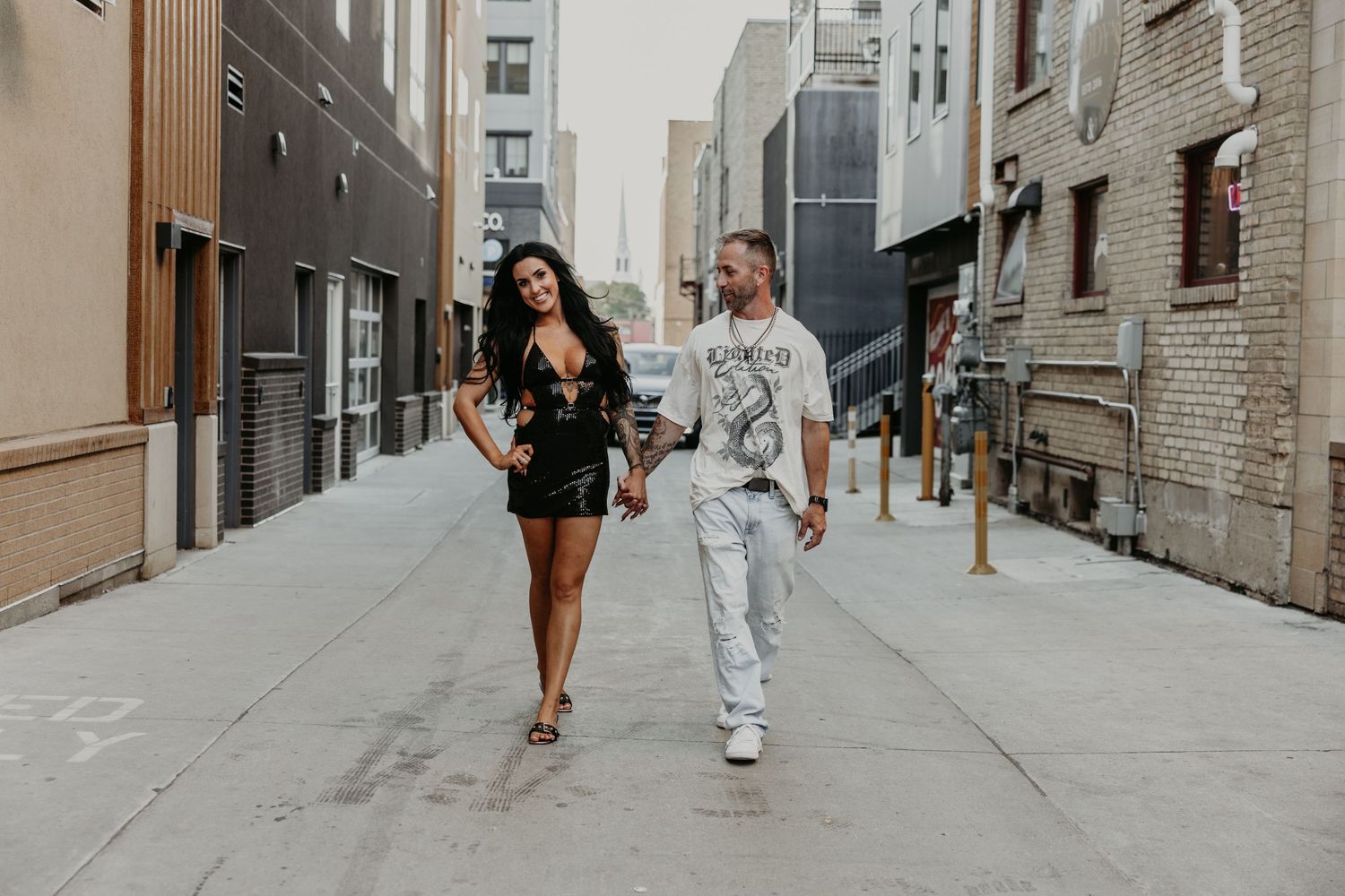 Urban photo session along brick buildings and city sidewalks.
