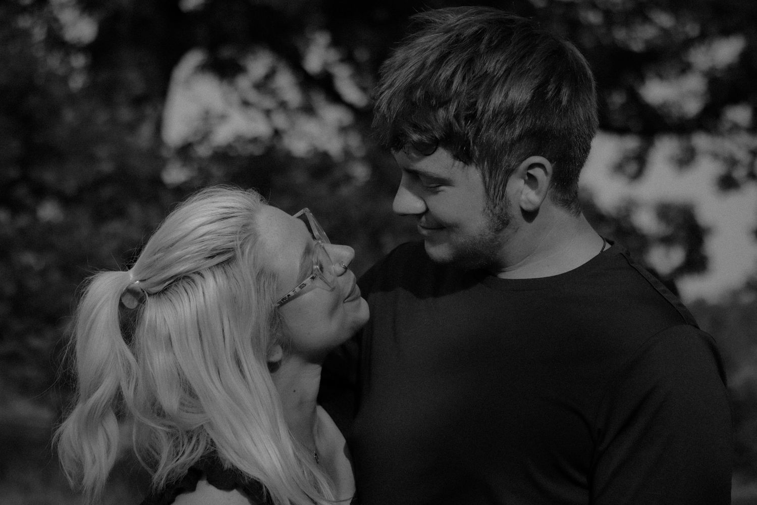 A romantic black and white montage showing intimate moments between couples in various outdoor settings.