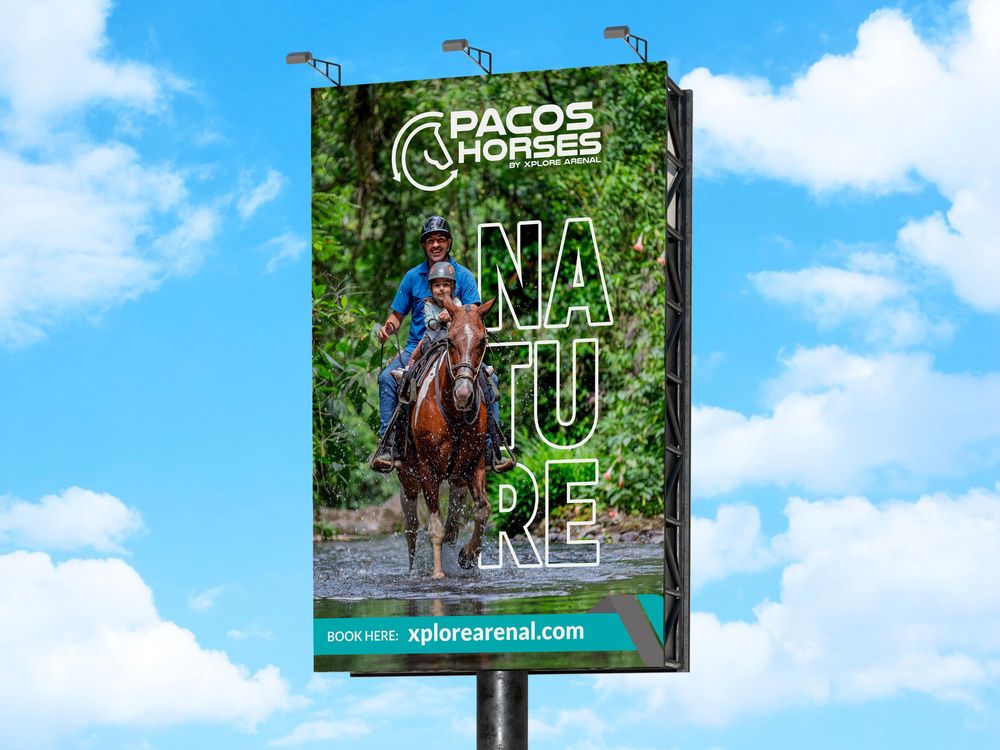 Large outdoor billboard featuring horseback riding and nature imagery for Pacos Horses against blue sky.