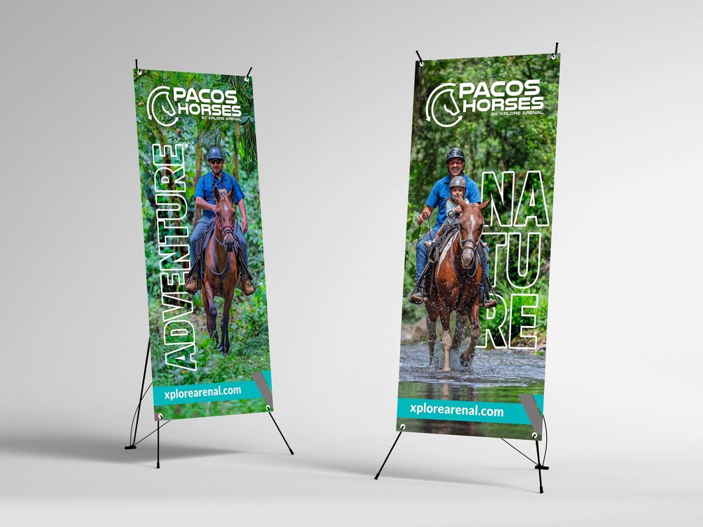 Two green banner stands displaying a horseback riding theme for Pacos Horses with nature scenery.