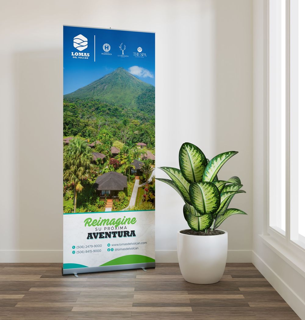 Adventure themed roll-up banner displaying mountain landscape next to potted plant.