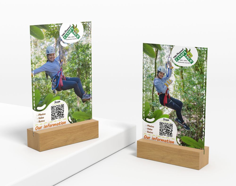 Two wooden display stands showcasing adventure activity photos with a natural backdrop.