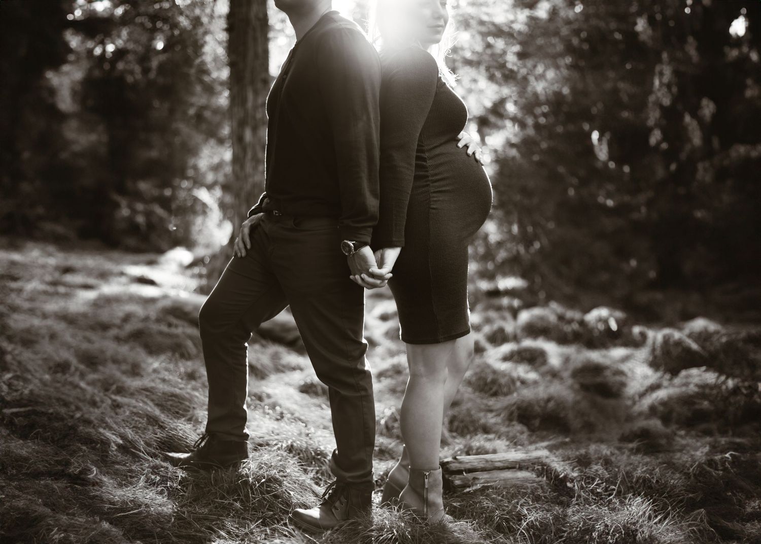 Silhouetted legs walking together in sunlit natural setting.