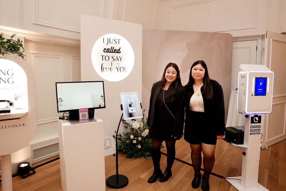 A photo booth setup with decorative backdrop and signage at an indoor event.