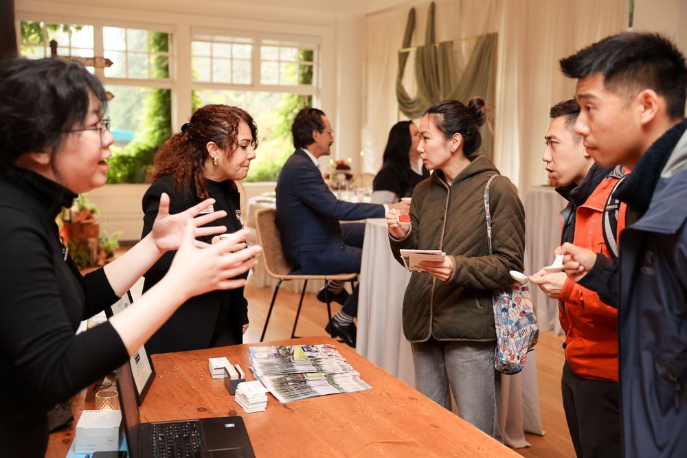 Animated discussion among attendees at an indoor networking event.