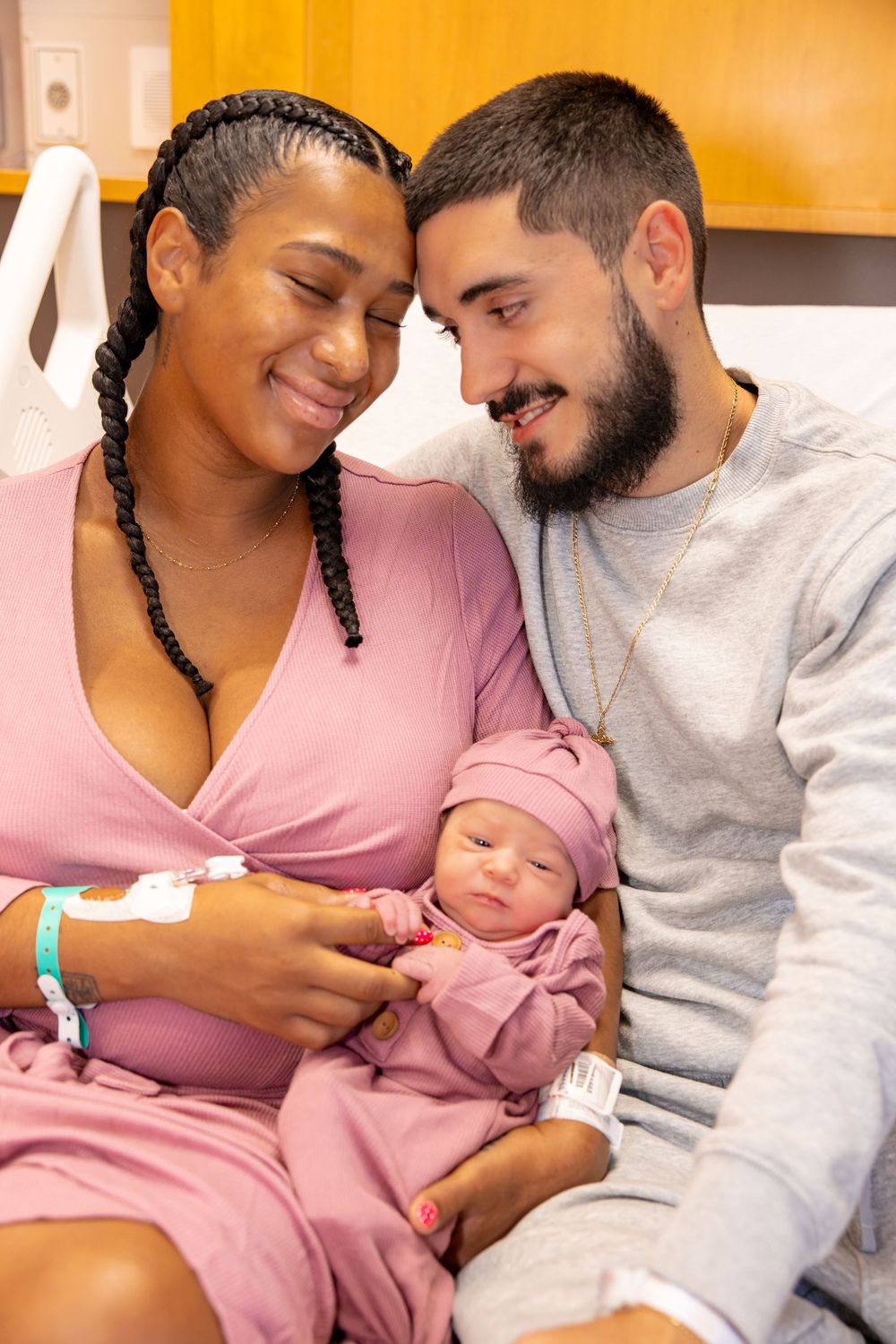 A couple shares tender moments with their newborn baby in a series of intimate hospital photos.