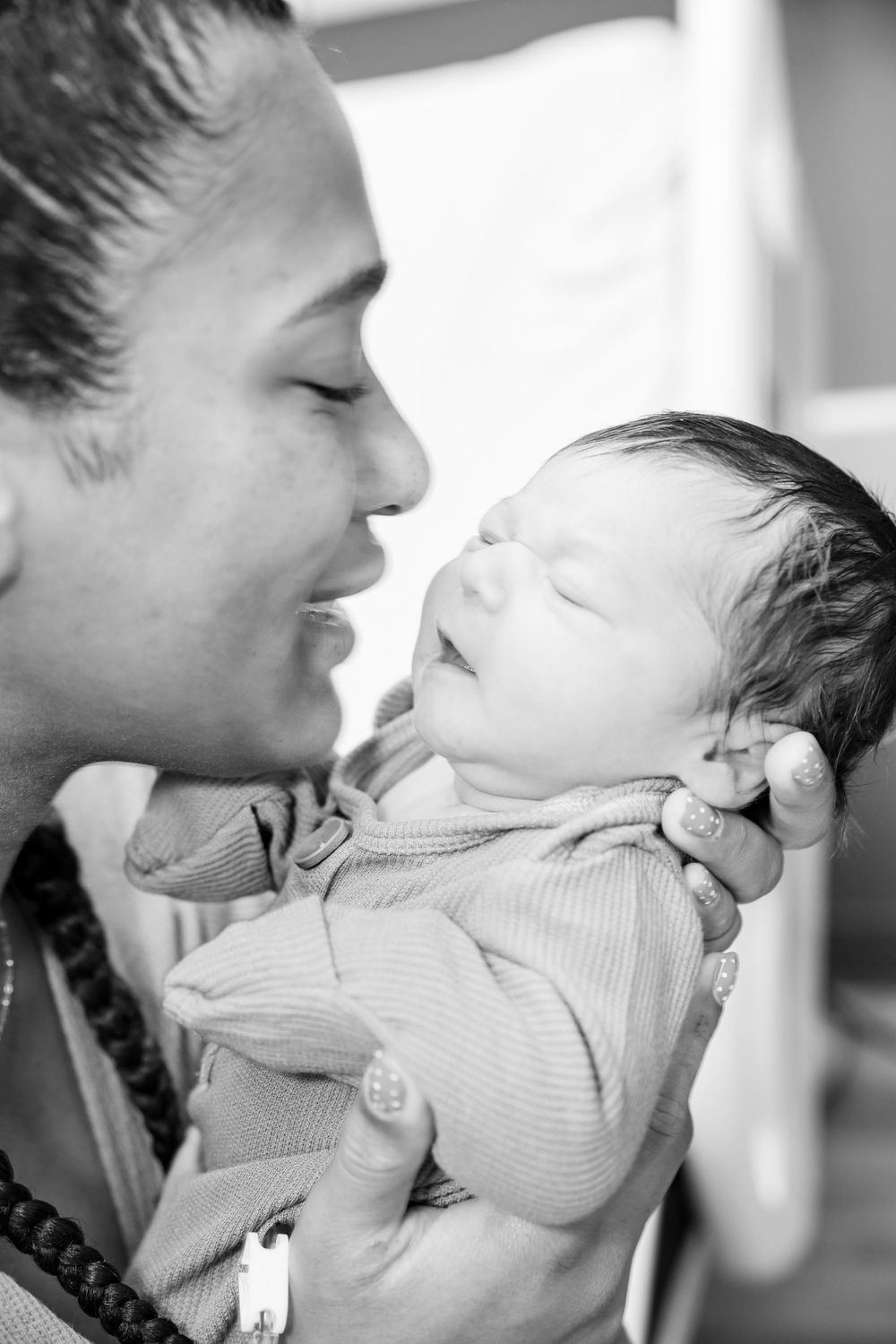 A black and white photo series showing intimate bonding moments between parent and infant.