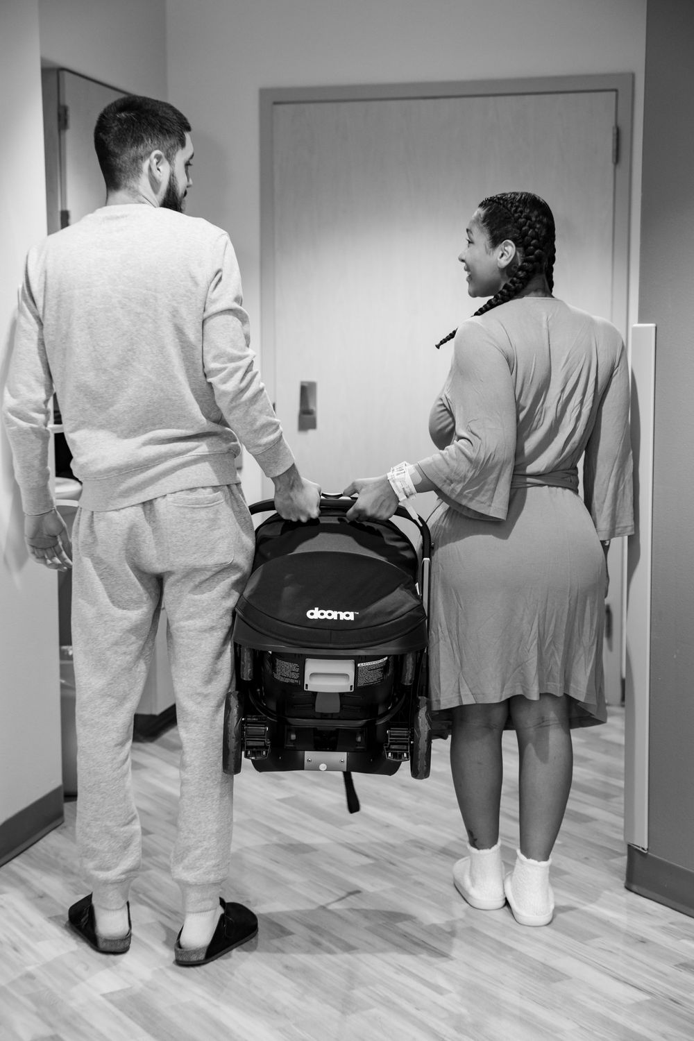 A sequence showing medical staff walking down a hospital hallway carrying equipment.