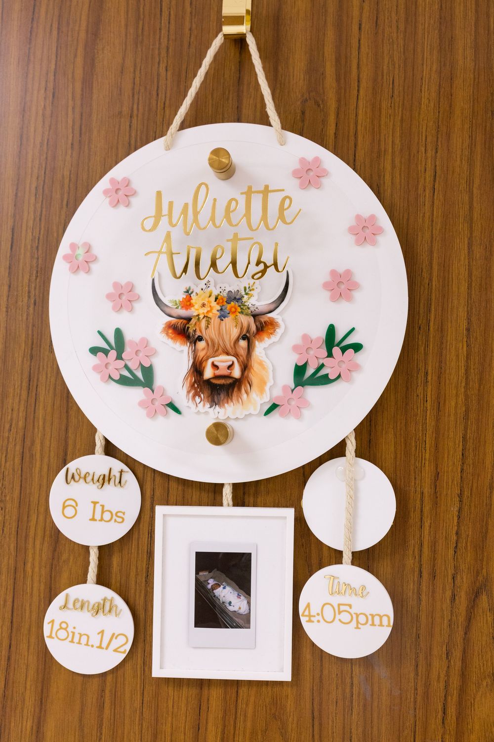 Decorative wooden wall signs with floral designs and personalized text in gold lettering.