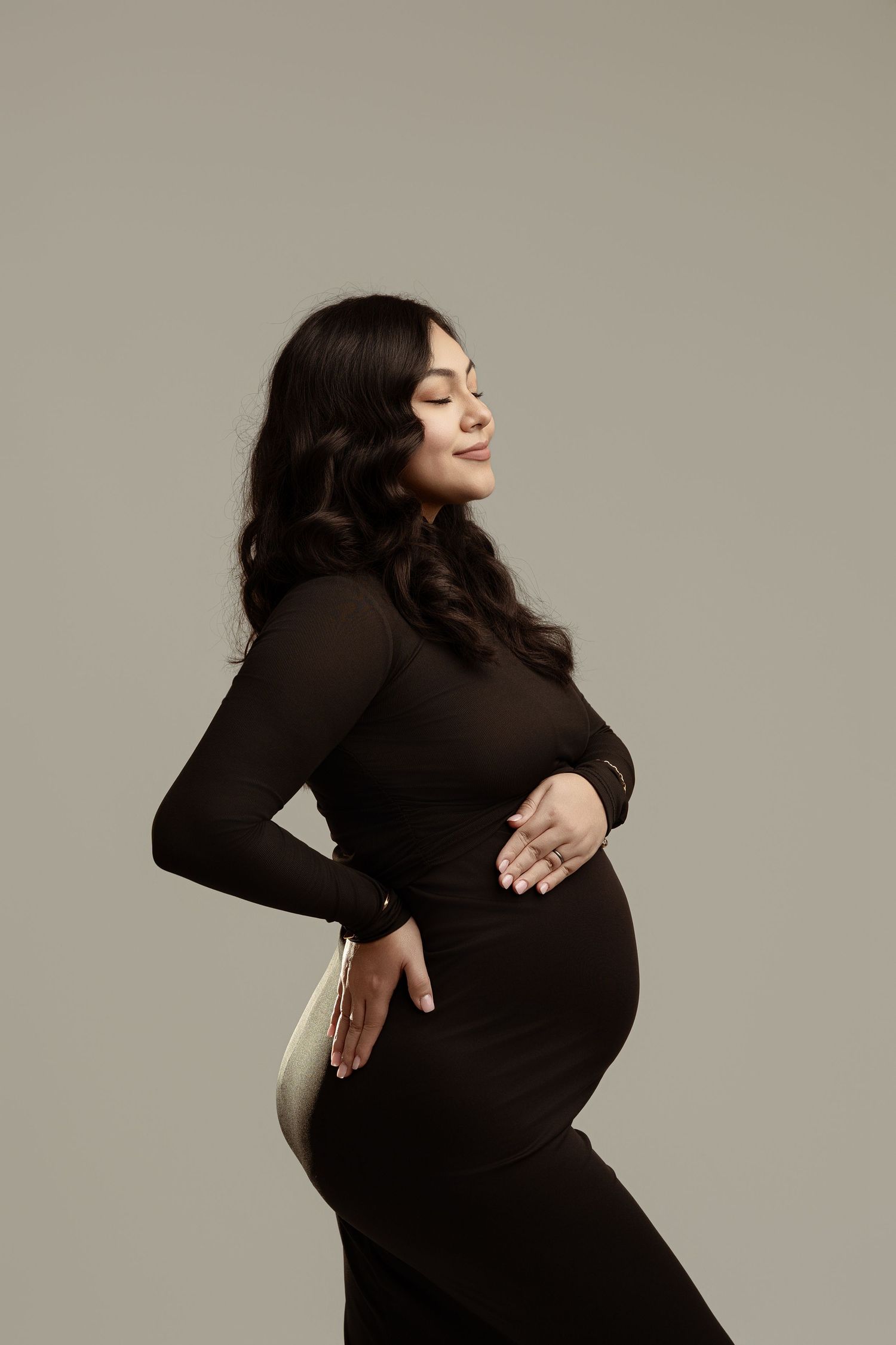 A maternity photo sequence shows a person in a black turtleneck posing against a neutral background. maternity photographer Paloma Schell