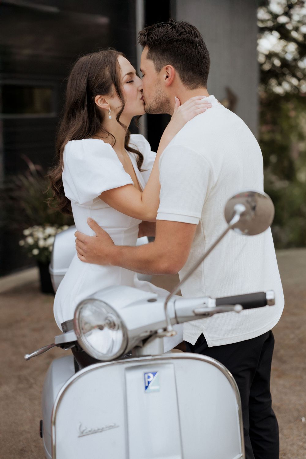 bride and groom kissing on moped European style elopement photography, vespa wedding photos, romantic wedding Moncton New Brunswick
