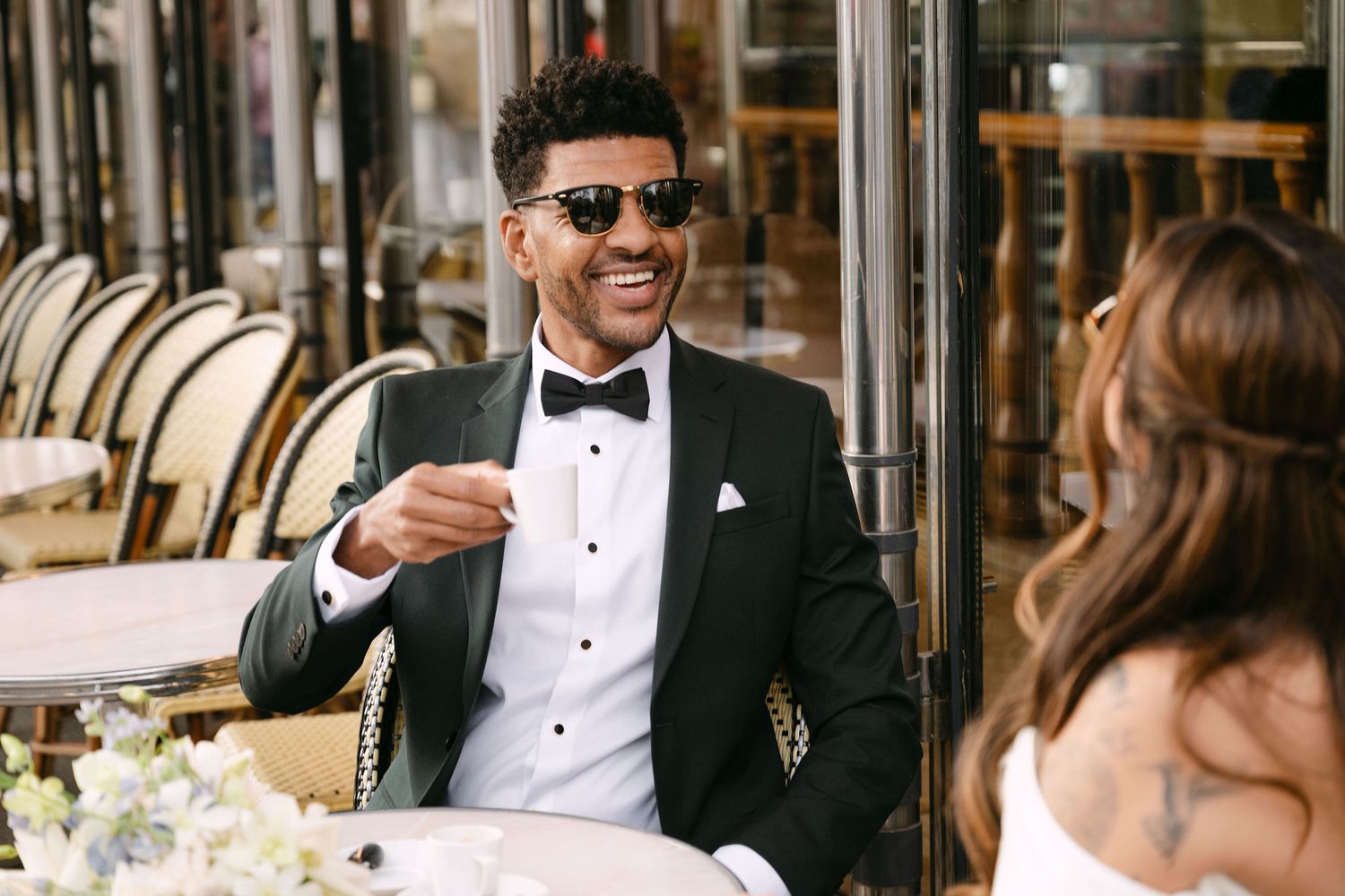Elegant wedding party celebration at an upscale venue with guests in formal black tie attire.