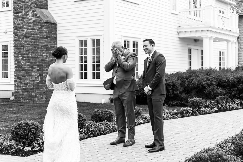 Black and white wedding photography sequence outside a traditional white house.