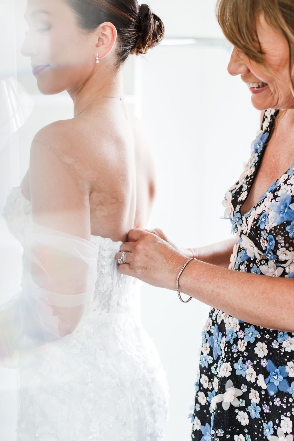Wedding dress fitting session showing delicate lace details and final adjustments.