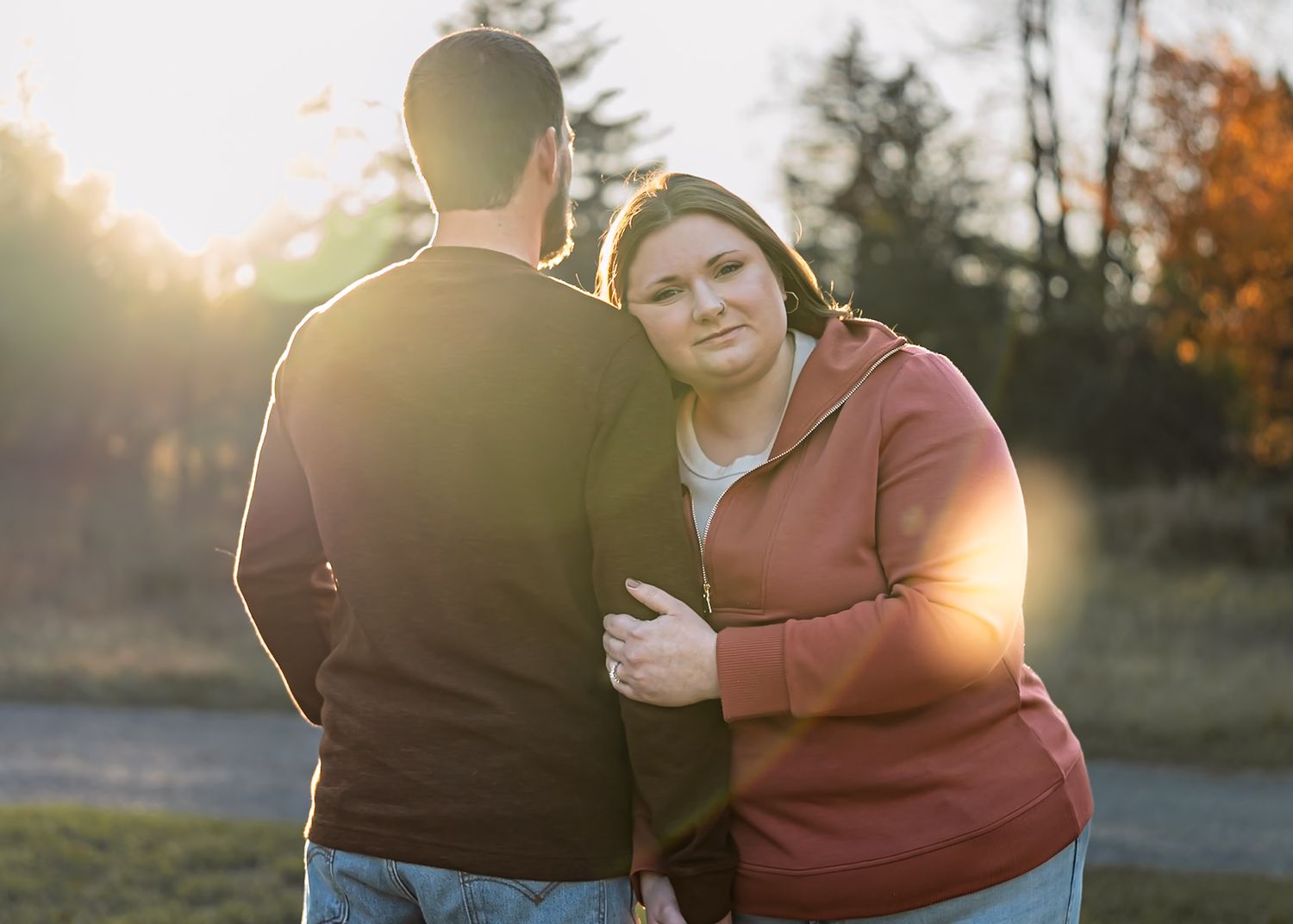 Sunset silhouette portrait with warm golden light and natural outdoor backdrop.