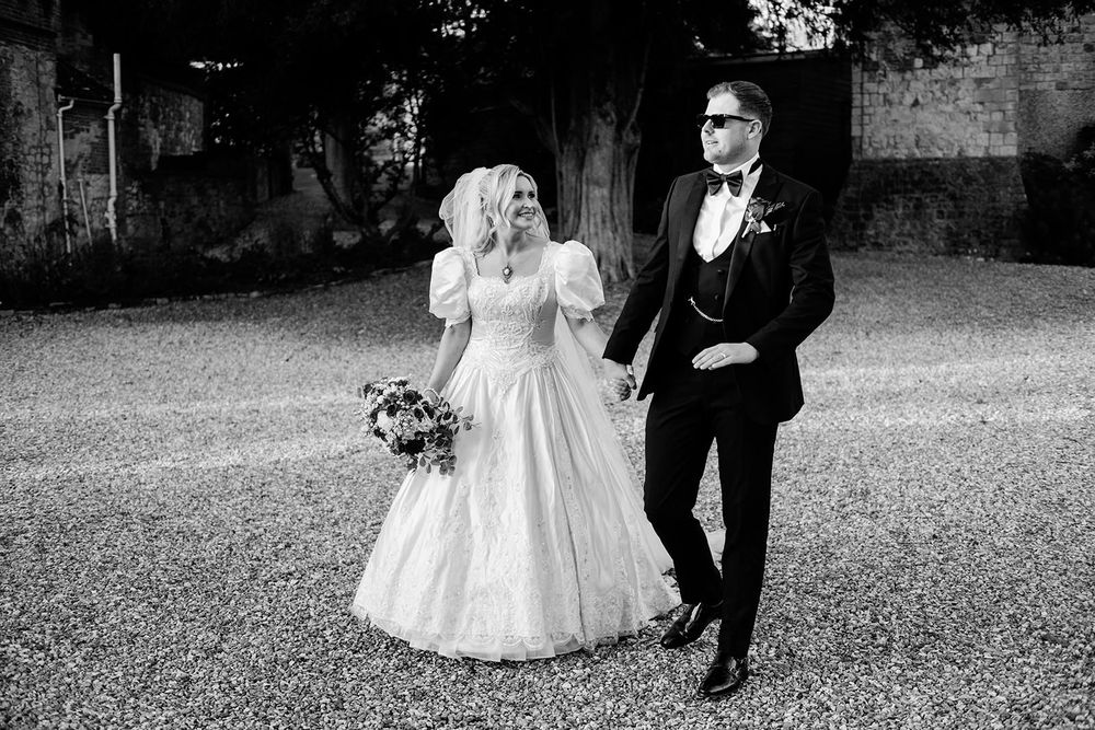 A black and white wedding photo collage showing romantic moments between a bride and groom outdoors.