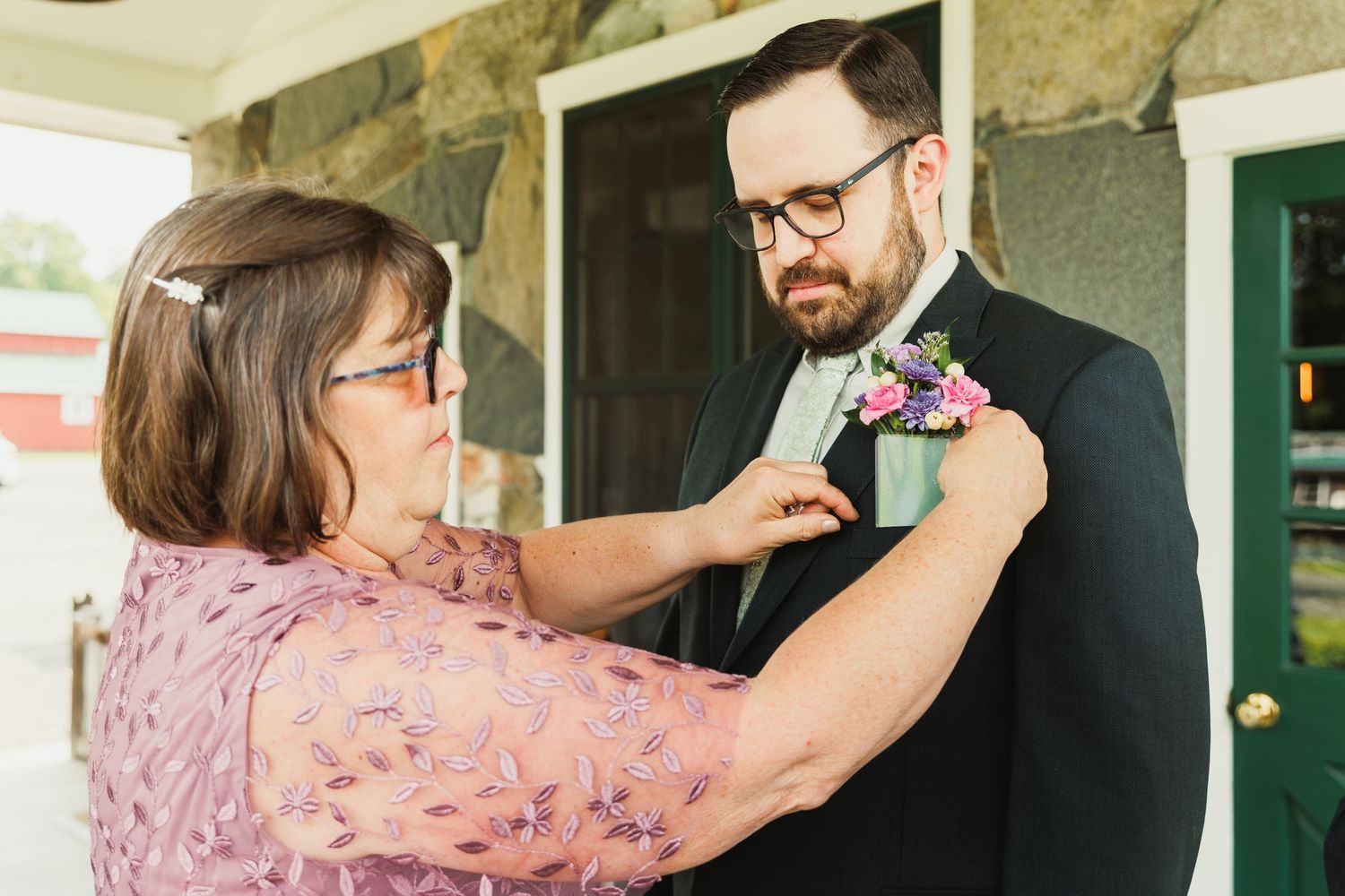 Wedding party members share a joyful dance moment during celebration.
