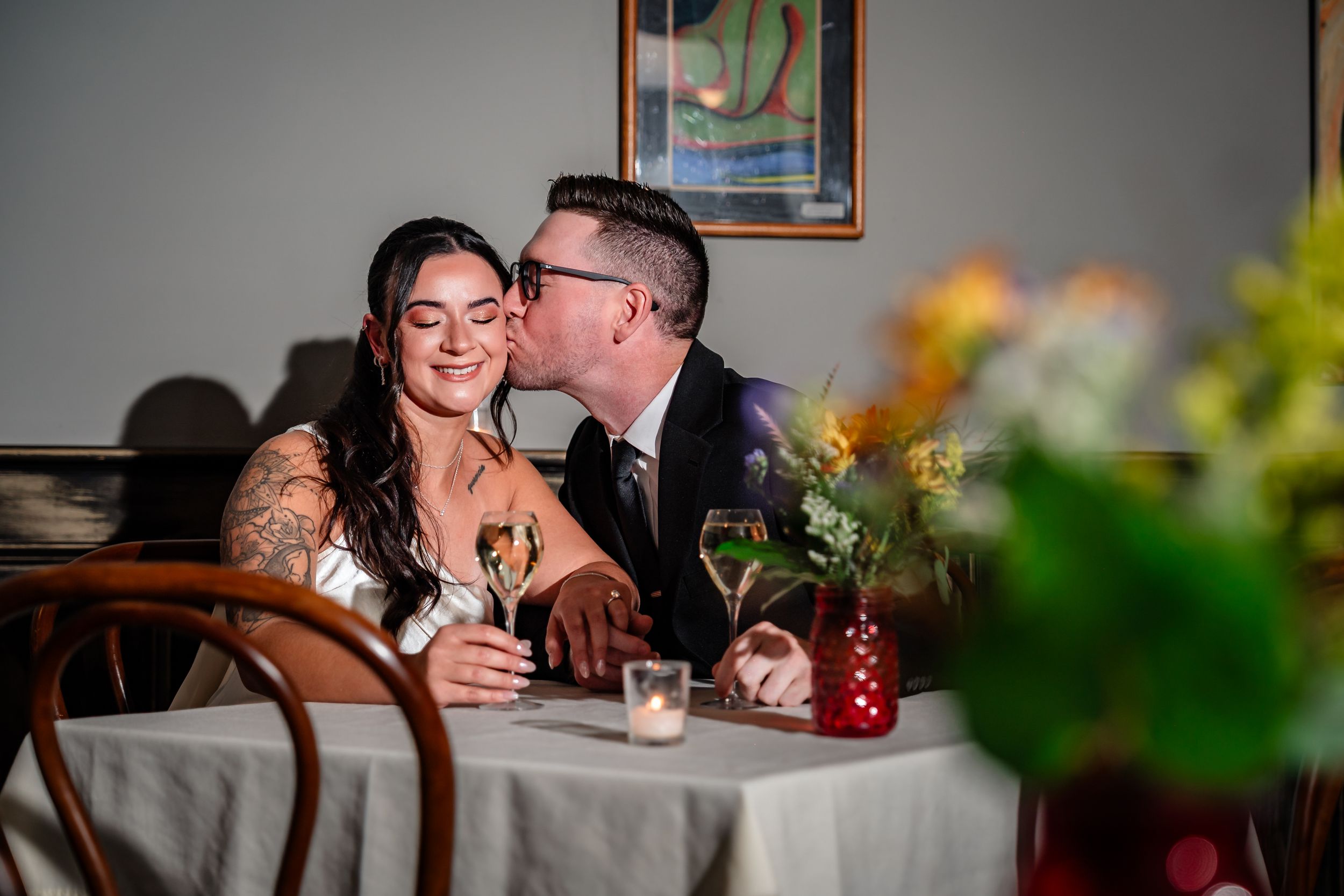 Romantic dining scene with wine glasses and intimate table settings in a restaurant.