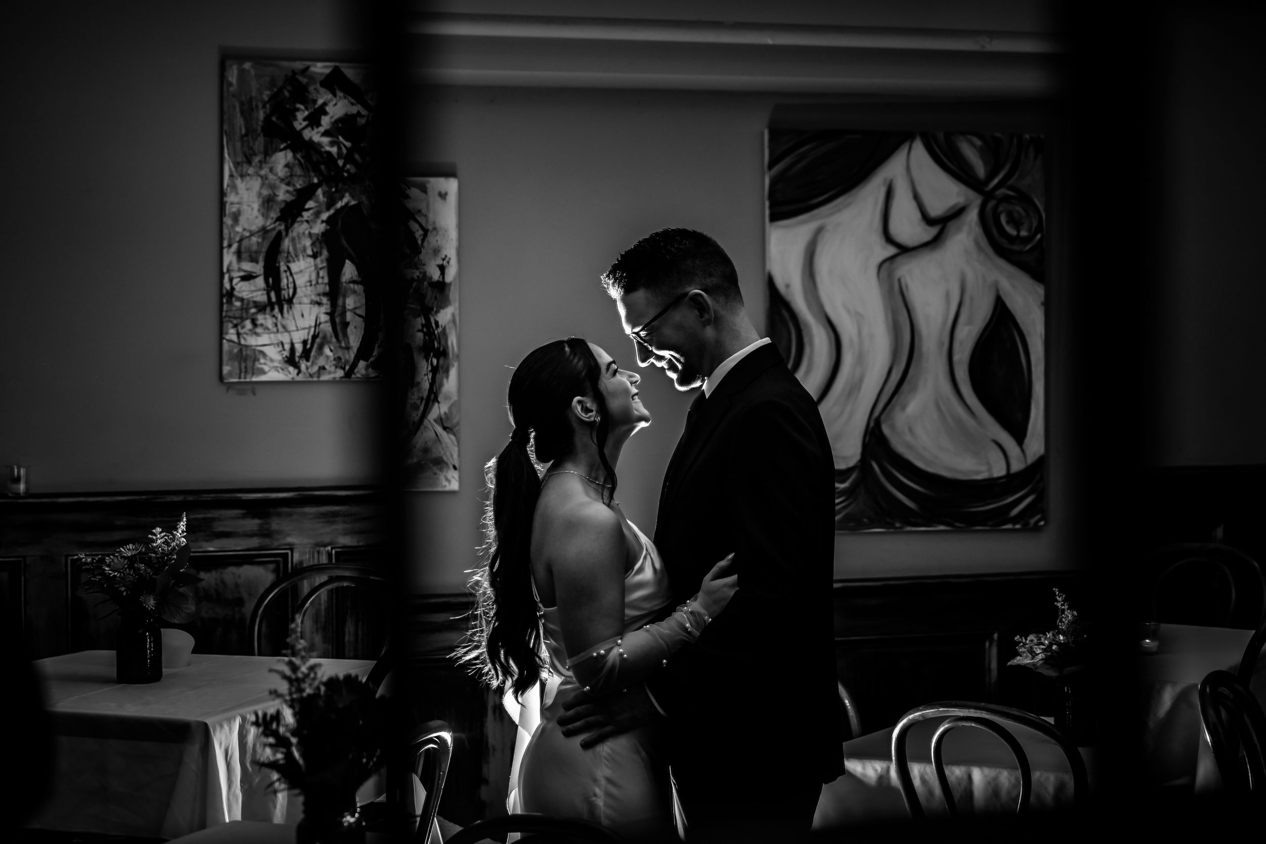 Black and white photo series showing intimate dance movements and poses between two performers on stage.