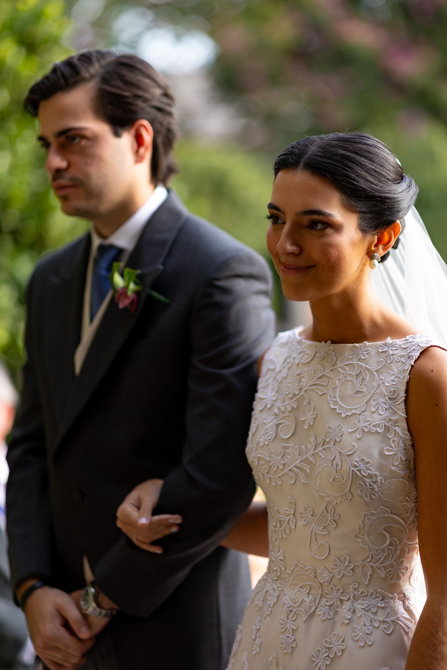 Candid moments captured during an outdoor wedding with guests in formal attire.