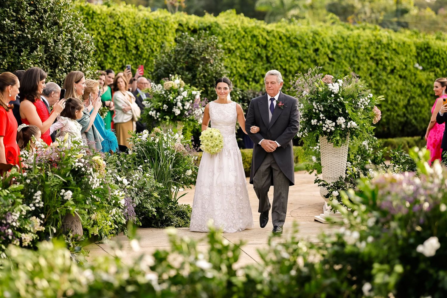 Lush garden setting with blooming flowers and greenery creates a beautiful backdrop for an outdoor gathering.