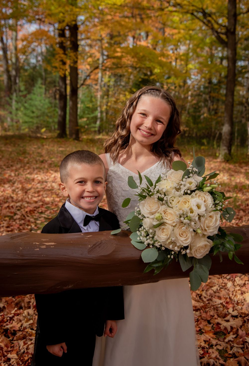 A heartwarming autumn photo session features formal attire and white floral bouquet arrangements.