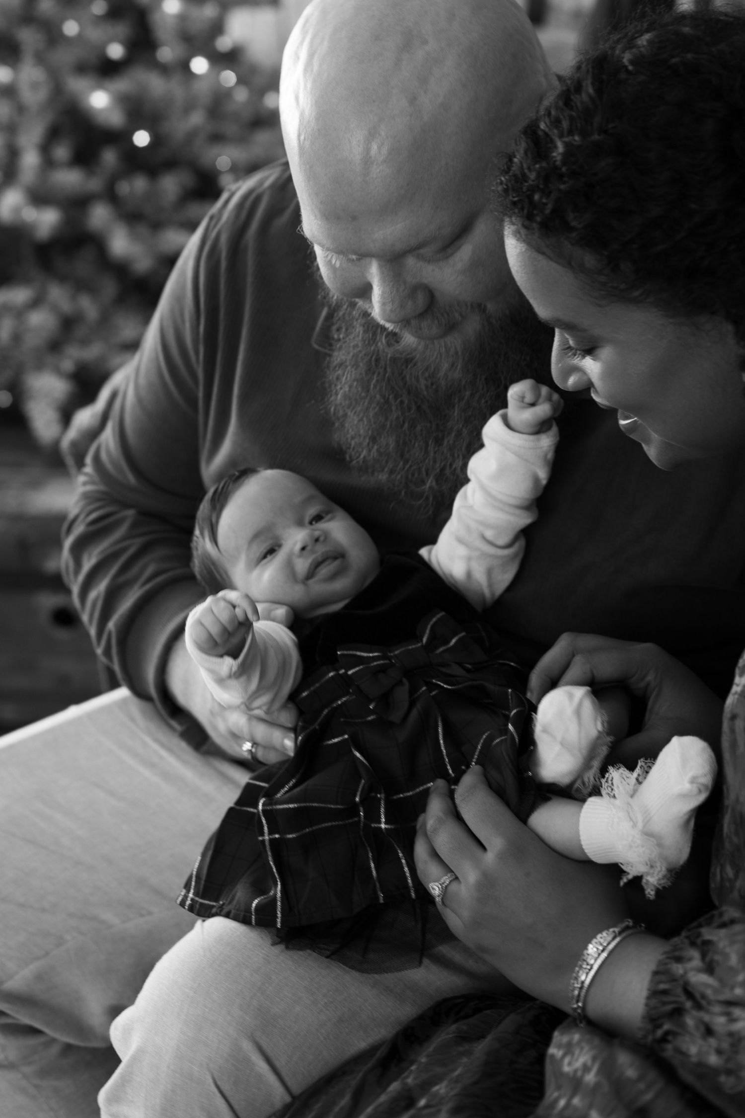 Cincinnati Christmas mini session featuring mom dad and baby holiday portraits with festive styling, warm indoor photography, and seasonal f