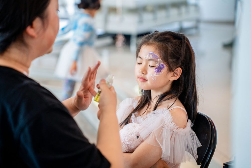 Auckland kids party photography capturing face painting activities and beautiful party food details.